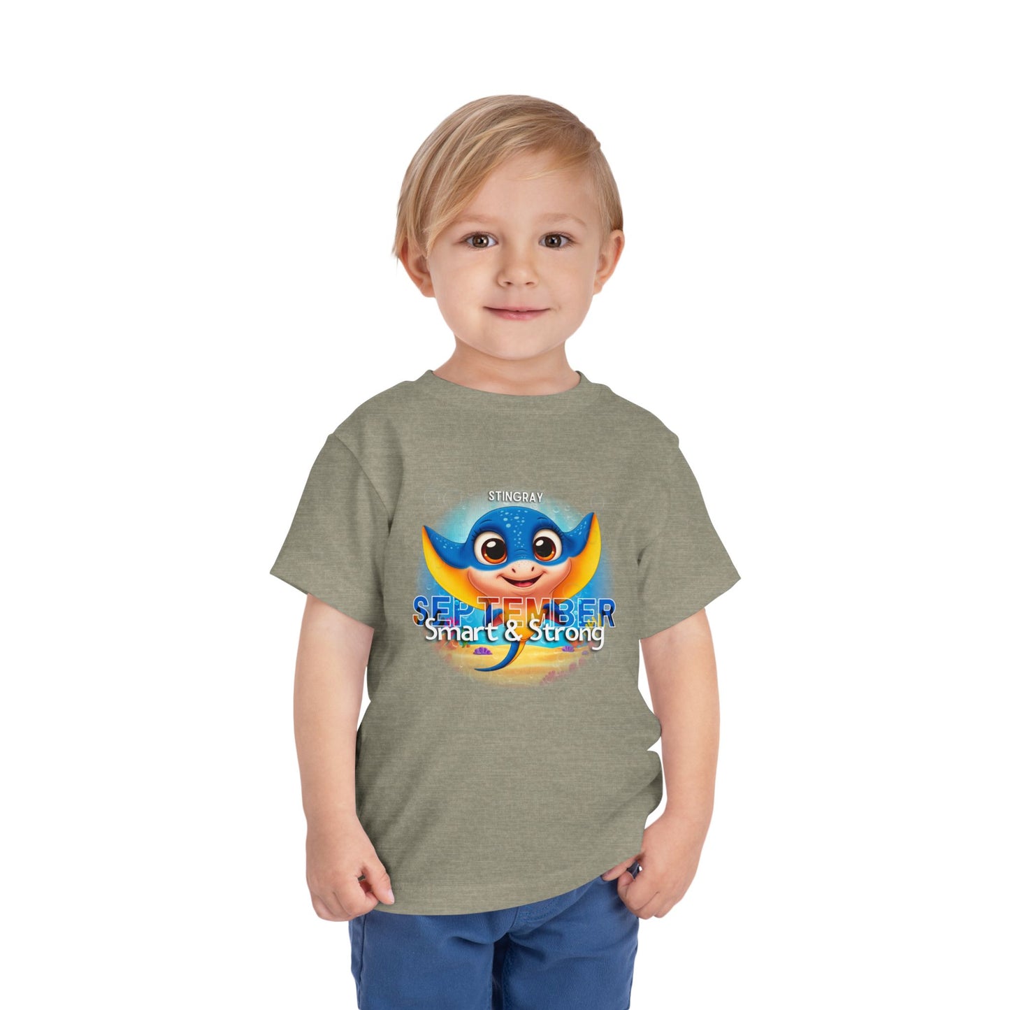Boy wearing Printify kids birth month tshirt with colorful September stingray design