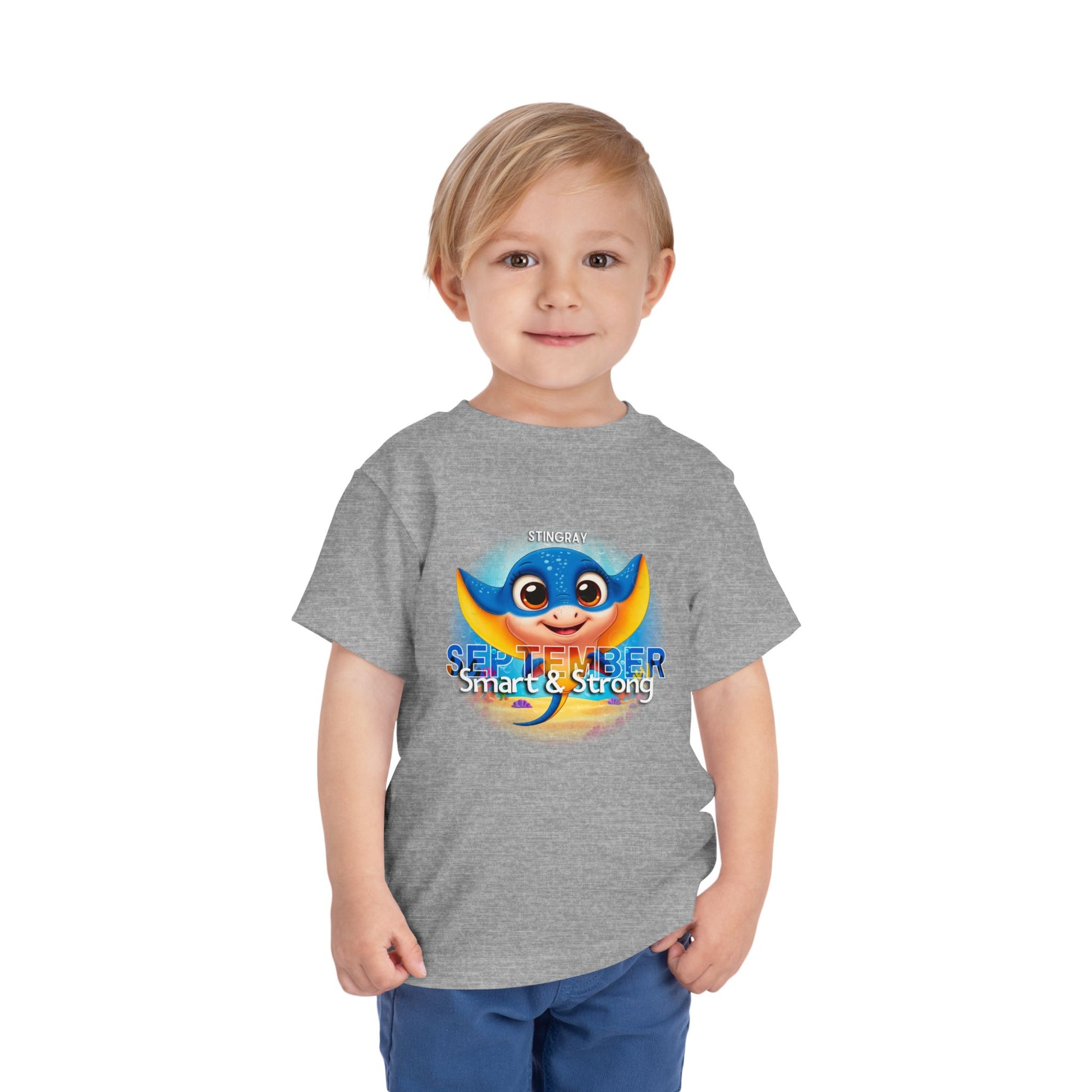 Toddler wearing a gray kids birth month tshirt with a colorful stingray and September text