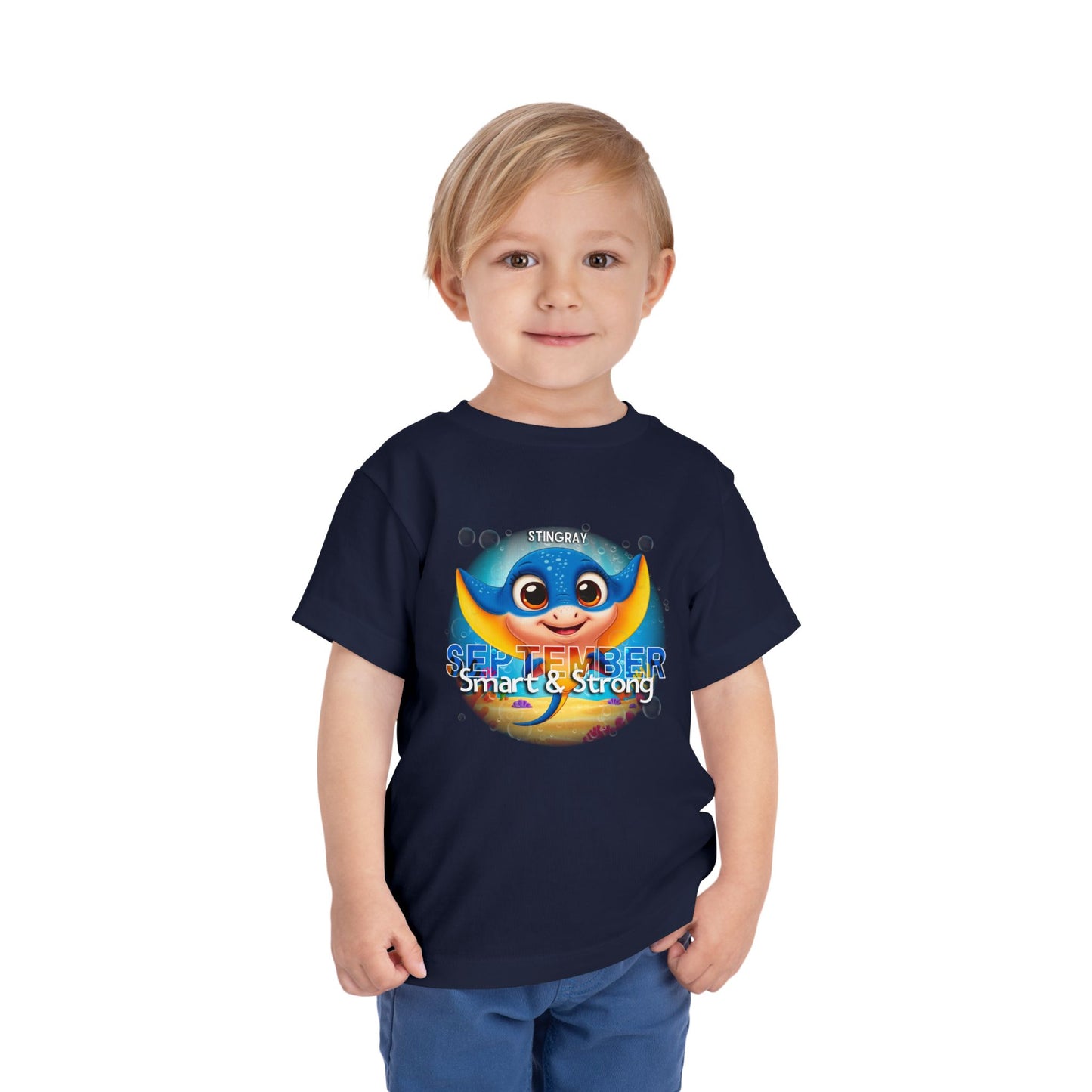 Toddler wearing a navy kids birth month tshirt with a colorful September stingray design