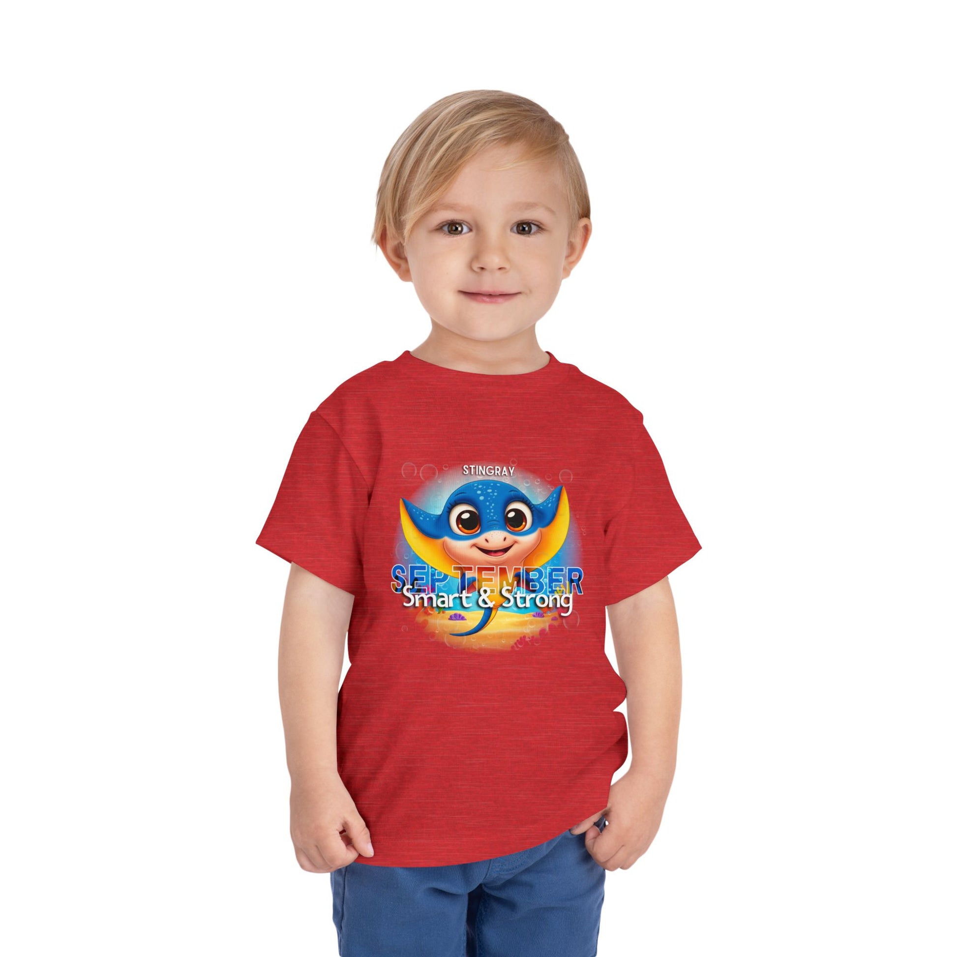 Toddler wearing red kids birth month tshirt with cartoon stingray and September design