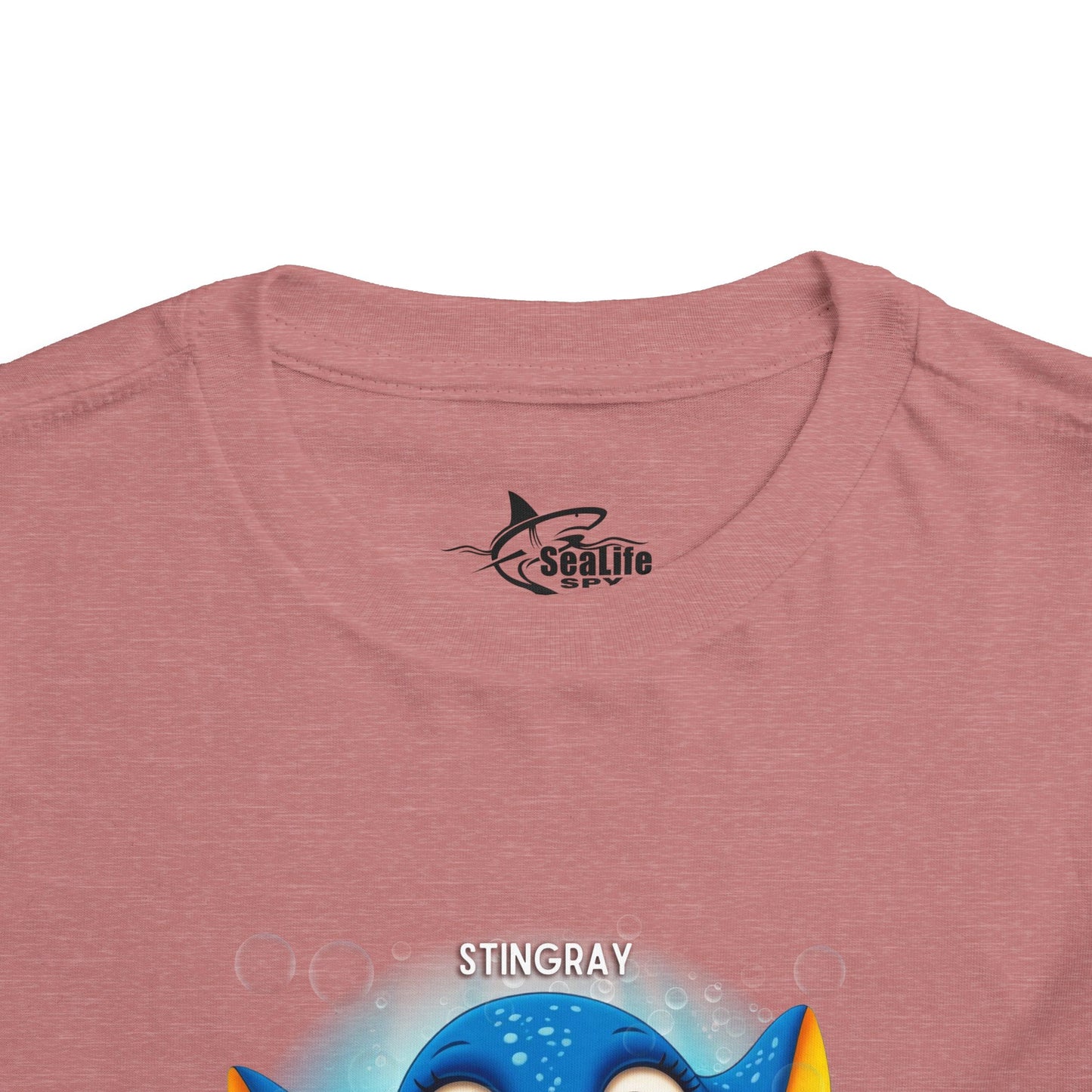 Kids birth month tshirt with colorful stingray graphic on a pink fabric background