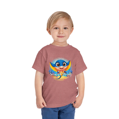 Toddler wearing a kids birth month tshirt with a colorful stingray and September text