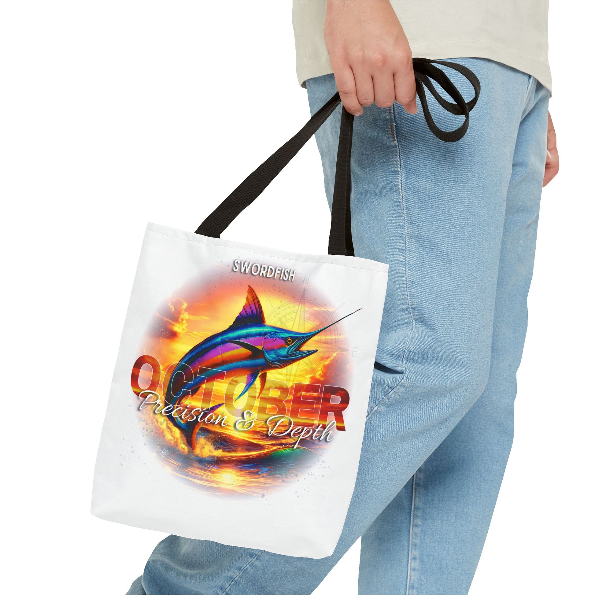 Birth month beach tote with swordfish October design carried by person wearing jeans