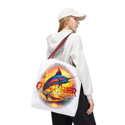 Birth month beach tote with colorful swordfish design worn by woman in white hoodie and cap