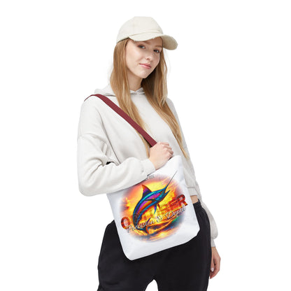 Woman wearing a birth month beach tote with colorful marlin fish design and sunset background