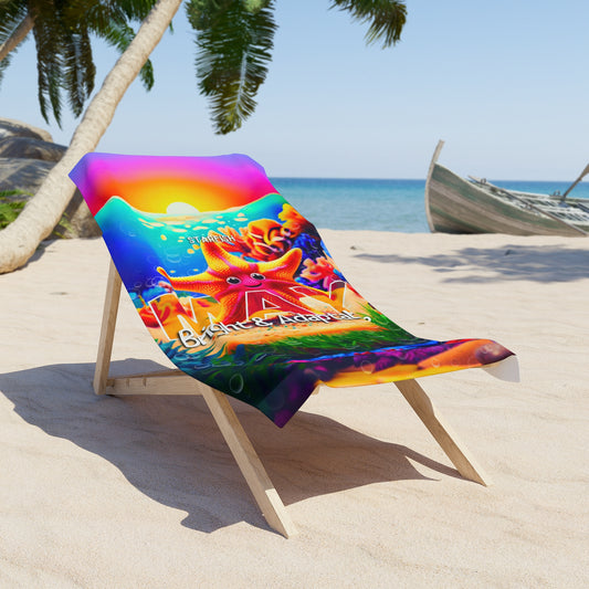 Colorful birth month kids beach towel with starfish design draped over wooden lounge chair on sandy beach